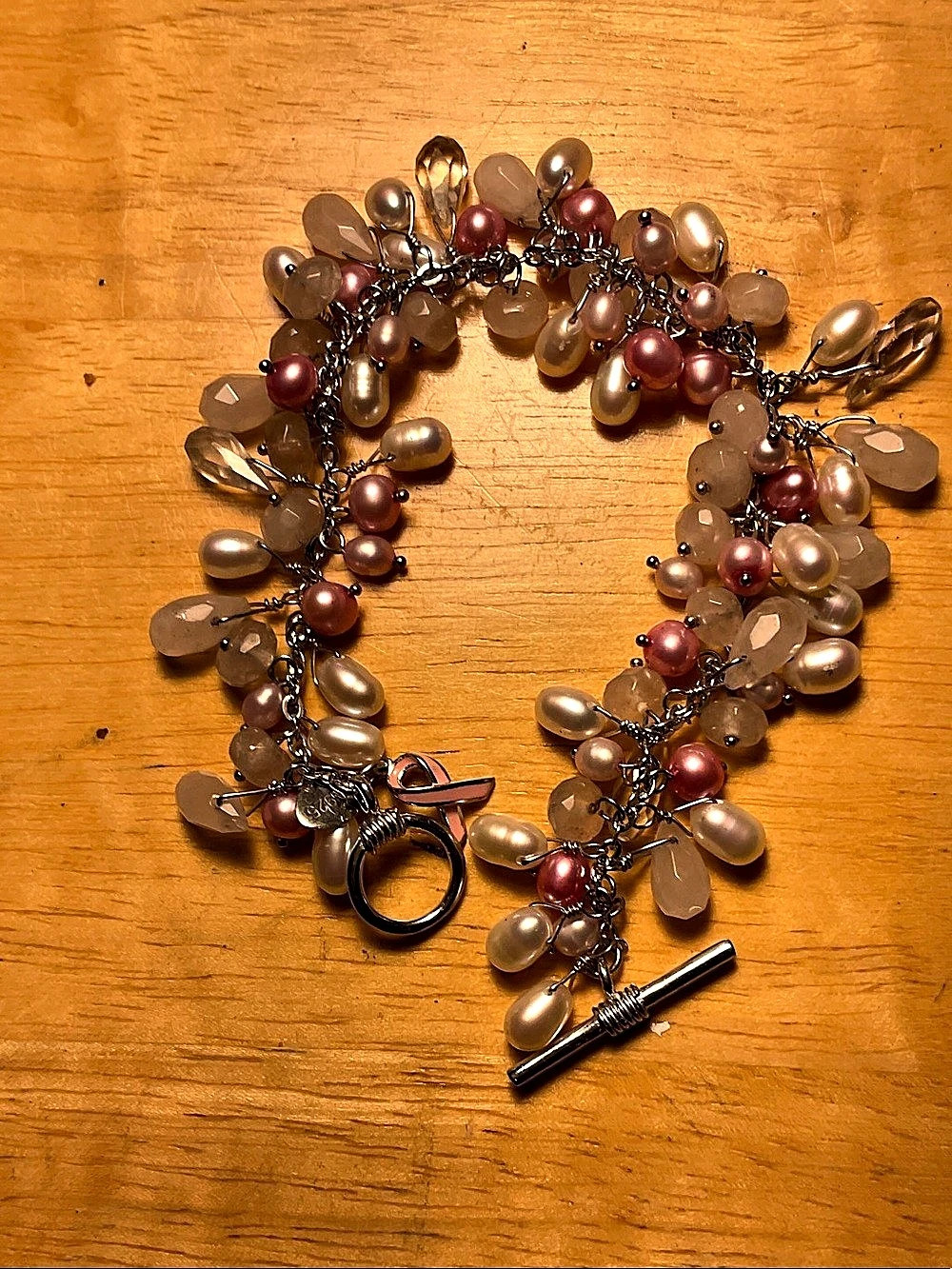 25.88 grams of silver and colored pearl charity bracelet.